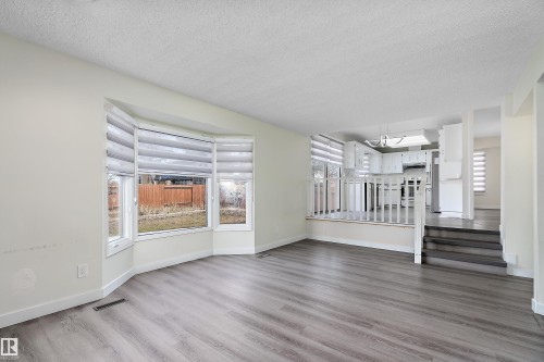 This property features an open living area with bay windows and wood flooring - 11020 158 Avenue, Edmonton, AB - Indoor