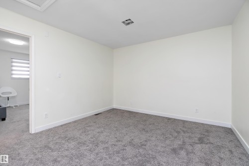 This room features a neutral color palette, grey carpeting, and white baseboards - 11020 158 Avenue, Edmonton, AB - Indoor Photo Showing Other Room