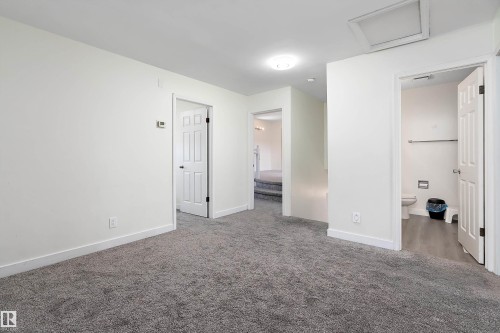 This interior space features clean white walls and plush grey carpeting - 11020 158 Avenue, Edmonton, AB - Indoor Photo Showing Other Room