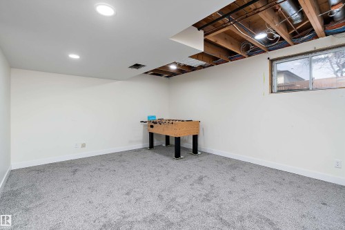 This room features recessed lighting, a window, and grey carpeting - 11020 158 Avenue, Edmonton, AB - Indoor Photo Showing Basement