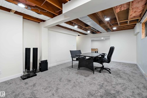 This spacious lower level features light grey carpeting, recessed lighting, and white walls - 11020 158 Avenue, Edmonton, AB - Indoor Photo Showing Basement