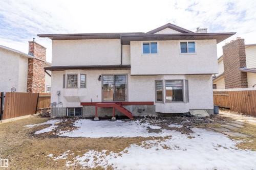 The property features a stucco exterior with a brown trim and a red deck - 11020 158 Avenue, Edmonton, AB - Outdoor