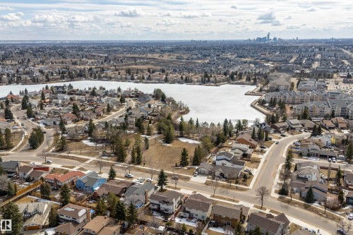 This property is situated within a established community, offering views of a nearby body of water and the distant skyline - 11020 158 Avenue, Edmonton, AB - Outdoor With View