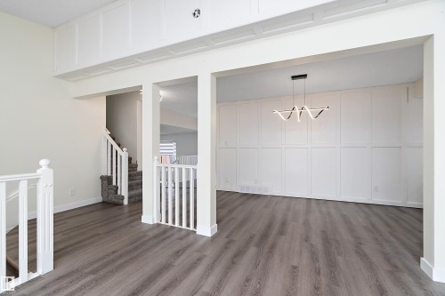 This bright interior space features light-colored walls and grey wood-look flooring - 11020 158 Avenue, Edmonton, AB - Indoor Photo Showing Other Room