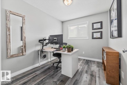 This room features durable flooring, a window offering natural light, and neutral wall tones - 8737 83 Avenue, Edmonton, AB - Indoor Photo Showing Office