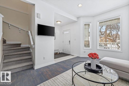 Living area featuring white walls, and a large window with natural light - 8737 83 Avenue, Edmonton, AB - Indoor Photo Showing Other Room