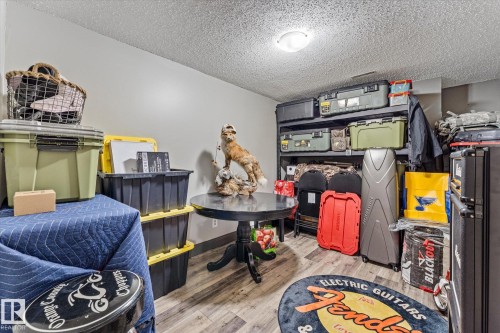 This space features light-colored walls and a textured ceiling with overhead lighting - 3908 44 Avenue, Stony Plain, AB - Indoor
