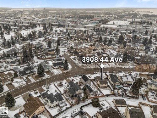 Aerial view of a residential neighborhood with houses featuring various roof styles and a street grid layout - 3908 44 Avenue, Stony Plain, AB -  With View