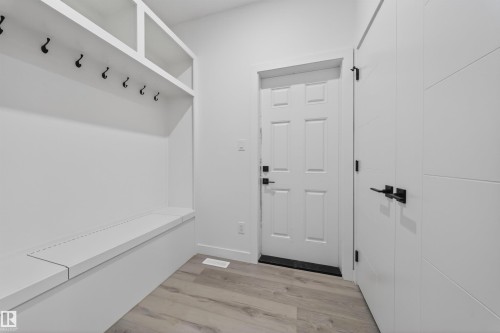 Entryway featuring built-in white cabinetry with open shelving and bench seating - 3906 41 Avenue, Beaumont, AB - Indoor