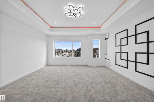 Spacious room featuring light gray carpet flooring and recessed lighting - 3906 41 Avenue, Beaumont, AB - Indoor Photo Showing Other Room