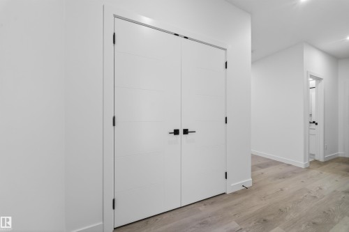 White paneled double doors with matte black hardware - 3906 41 Avenue, Beaumont, AB - Indoor Photo Showing Other Room