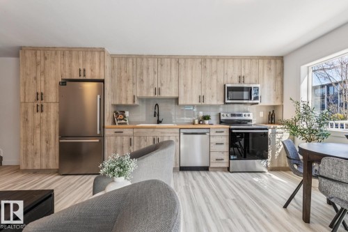 Modern kitchen featuring wood-finish cabinetry, stainless steel appliances, and wood-finish countertops - 10726 107 Street, Edmonton, AB - Indoor Photo Showing Kitchen With Stainless Steel Kitchen