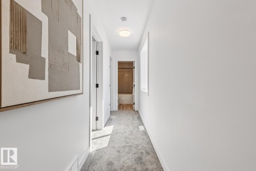 Bright hallway featuring plush gray carpeting, white painted walls, and a recessed window - 10726 107 Street, Edmonton, AB - Indoor Photo Showing Other Room