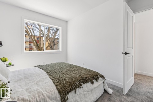 Bedroom featuring a large window, white walls, and gray carpet flooring - 10726 107 Street, Edmonton, AB - Indoor Photo Showing Bedroom