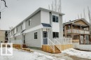 Contemporary multi-level exterior featuring light grey horizontal siding and white vertical siding accents - 10726 107 Street, Edmonton, AB  - Outdoor With Deck Patio Veranda 