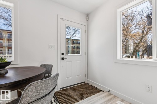 Bright interior featuring a white paneled door with glass inserts and black hardware - 10726 107 Street, Edmonton, AB - Indoor