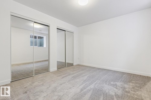 Room featuring expansive mirrored closet doors - 10726 107 Street, Edmonton, AB - Indoor Photo Showing Other Room