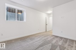 Spacious room featuring a white-framed window with a metal window well - 