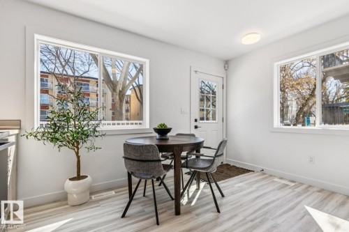 Bright dining area featuring light wood-finish flooring - 10726 107 Street, Edmonton, AB - Indoor Photo Showing Dining Room