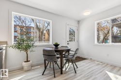 Bright dining area featuring light wood-finish flooring - 