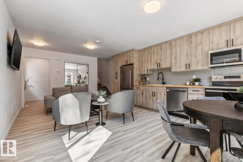 Open-concept living space featuring wood-finish flooring throughout - 10726 107 Street, Edmonton, AB - Indoor
