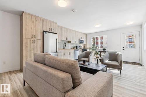 Open-concept living area with light wood-finish flooring - 10726 107 Street, Edmonton, AB - Indoor Photo Showing Living Room