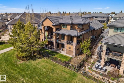 Multi-level residence featuring a stucco and stone exterior with a 100 year clay tile roof and walkout basement backing onto Hyman Pond. - 3048 Watson Landing, Edmonton, AB - Outdoor