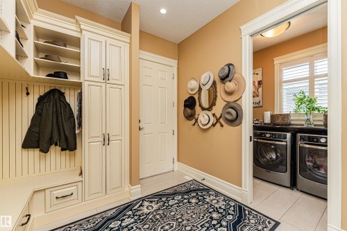 Back entrance from garage and a peek at the laundry room. - 3048 Watson Landing, Edmonton, AB - Indoor Photo Showing Laundry Room