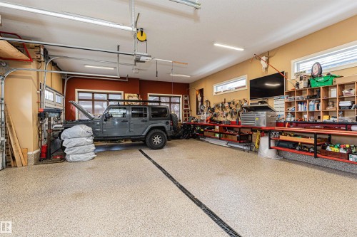 A dream triple oversized garage. Heated with Epoxy floors. - 3048 Watson Landing, Edmonton, AB - Indoor Photo Showing Garage
