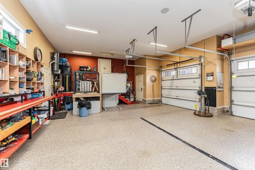 A dream triple oversized garage. Heated with Epoxy floors. - 3048 Watson Landing, Edmonton, AB - Indoor Photo Showing Garage