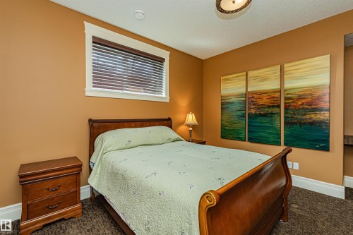 This inviting room features a window with blinds, carpeted flooring, and a ceiling light fixture - 3048 Watson Landing, Edmonton, AB - Indoor Photo Showing Bedroom