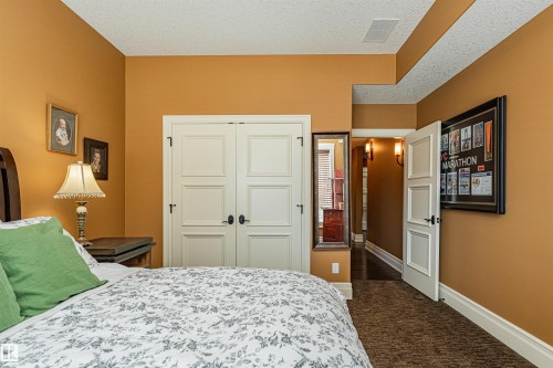 This room features warm-toned walls, white trim, and a textured carpet - 3048 Watson Landing, Edmonton, AB - Indoor Photo Showing Bedroom