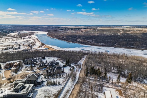Expansive aerial perspective showcasing a river, bordering wooded areas, and a residential community - 3048 Watson Landing, Edmonton, AB - Outdoor With View