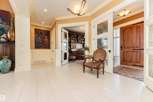The entry area features light-colored rectangular floor tiles, crown molding, and recessed lighting - 3048 Watson Landing, Edmonton, AB - Indoor Photo Showing Other Room