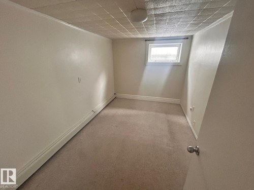 Compact room featuring neutral carpeting and light-toned walls - 11242 56 Street, Edmonton, AB - Indoor Photo Showing Other Room