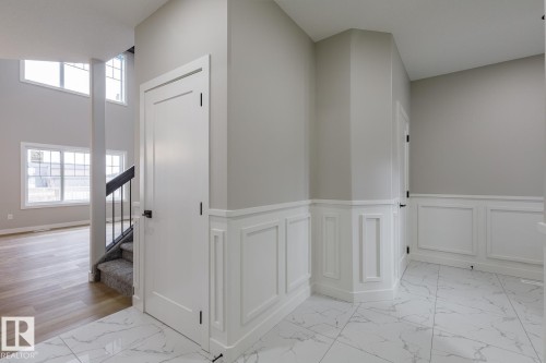 Entryway featuring white wainscoting and marble-look flooring - 917 Elderberry Landing, Edmonton, AB - Indoor Photo Showing Other Room