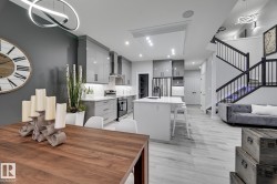 Open-concept living space with light wood-finish flooring - 