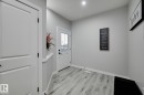 Entryway featuring wood-finish flooring, white trim, and a white paneled door - 1774 Crossbill Loop, Edmonton, AB  - Indoor Photo Showing Other Room 