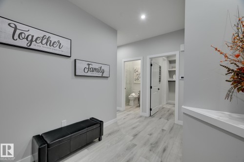 Hallway featuring light wood-finish flooring, recessed ceiling lighting, and crisp white baseboards - 1774 Crossbill Loop, Edmonton, AB - Indoor Photo Showing Other Room