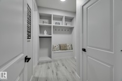 Built-in mudroom bench with storage cubbies and coat hooks - 