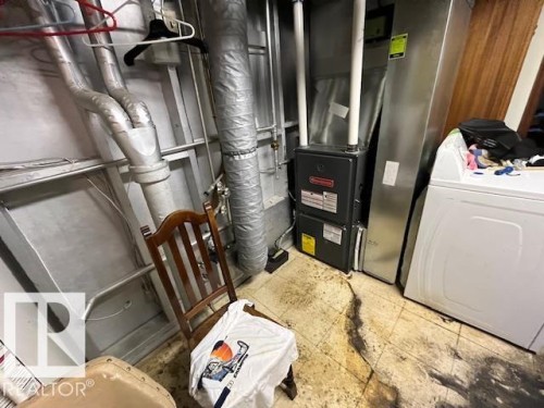 Utility area featuring a furnace and a white washing machine - 11003 144 Street, Edmonton, AB - Indoor Photo Showing Basement
