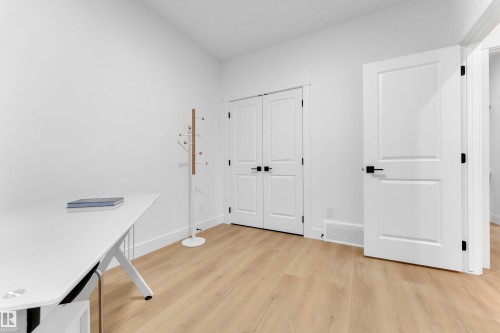Spacious room featuring light wood-finish flooring, white baseboards, and white walls - 247 Linden Loop, Leduc, AB - Indoor Photo Showing Other Room