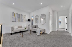 Carpeted loft area featuring white walls, recessed lighting, and a contemporary railing with black spindles - 