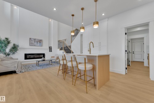 Open-concept living area featuring high ceilings and light wood-finish flooring - 247 Linden Loop, Leduc, AB - Indoor With Fireplace