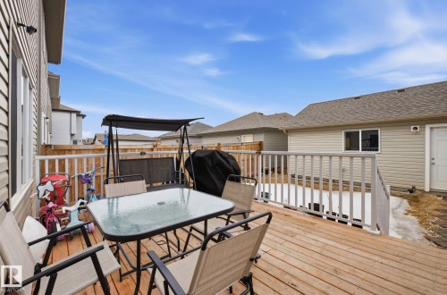 The property features a spacious wooden deck, complete with a railing, providing outdoor living space - 4636 175 Ave, Edmonton, AB - Outdoor With Deck Patio Veranda With Exterior