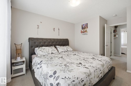 This bedroom features light-colored walls and plush carpeting - 4636 175 Ave, Edmonton, AB - Indoor Photo Showing Bedroom