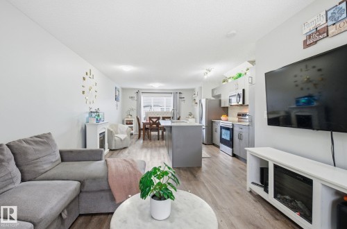Open concept living space featuring hardwood style flooring, a neutral color palette, and recessed lighting - 4636 175 Ave, Edmonton, AB - Indoor Photo Showing Living Room