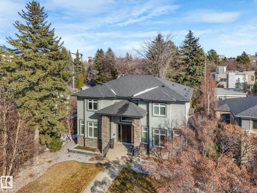 Contemporary two-story residence featuring a gray exterior, stone accents, and a dark shingle roof - 8927 120 Street, Edmonton, AB - Outdoor