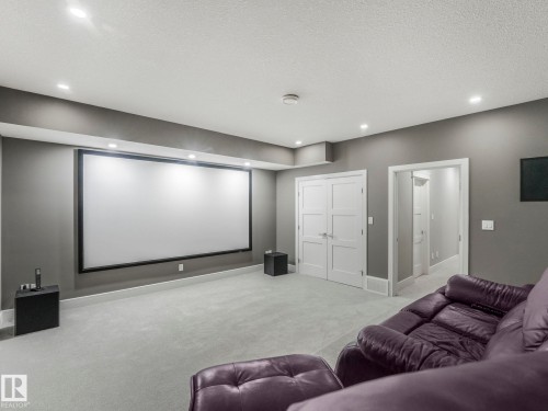 Sound proofed media room with high end projector and elevated seating platform. - 8927 120 Street, Edmonton, AB - Indoor Photo Showing Other Room
