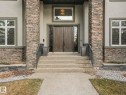 Stucco and stone facade with a double entry door, transom window, and substantial stone pillars - 8927 120 Street, Edmonton, AB  - Outdoor 